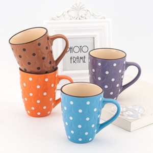 Embossed ceramic mug with dots painted